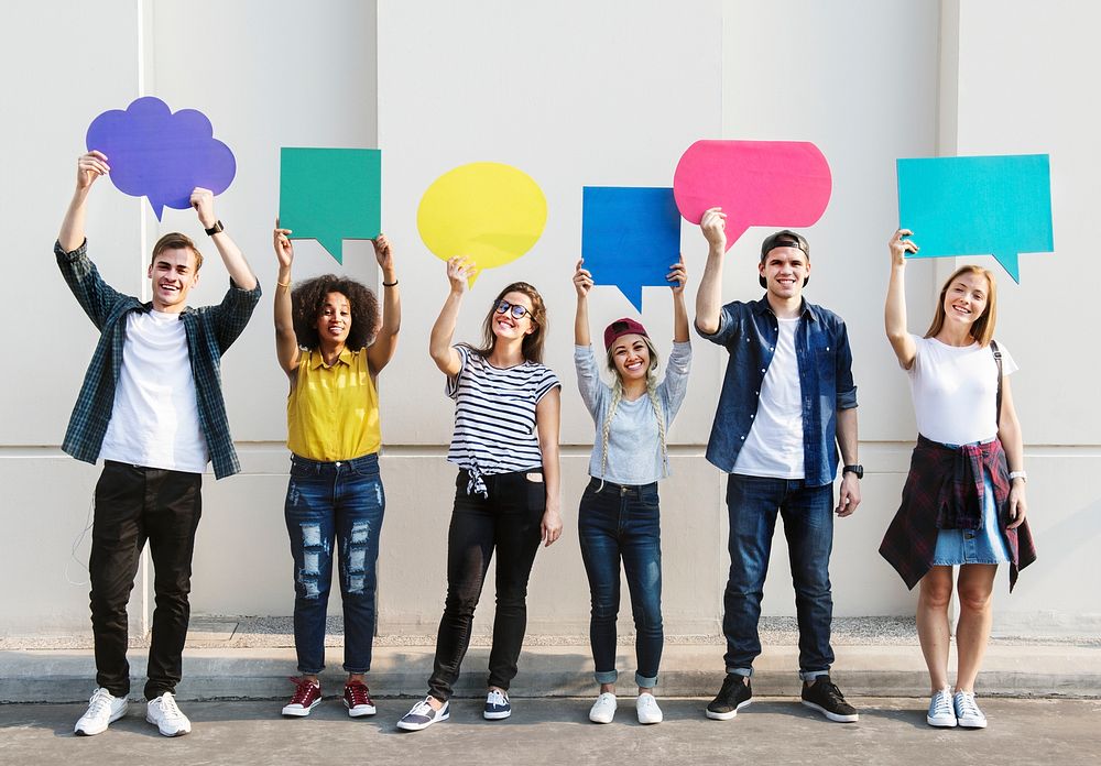 Young adult friends holding up copyspace placard thought bubbles